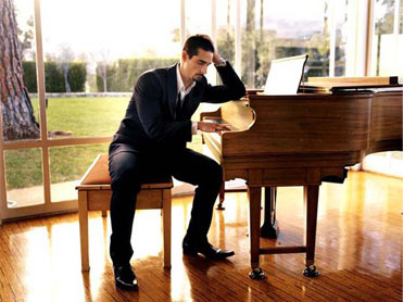 Kevin sitting at a piano